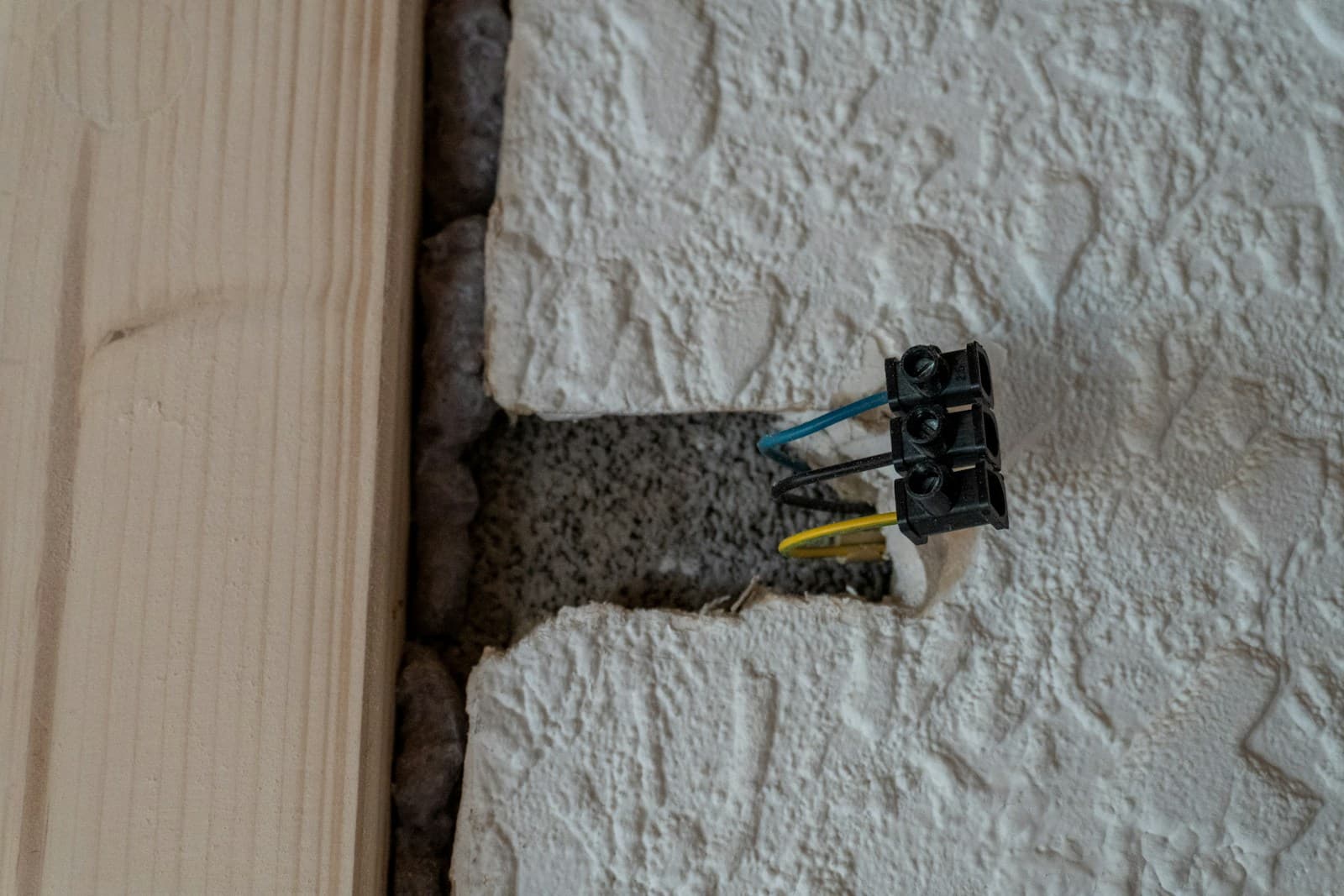 Conductors and a terminal in a chased opening in a wall.